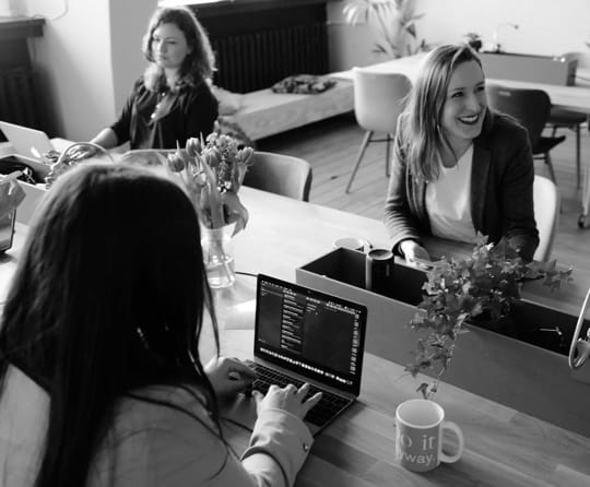 Header image - happy employees in the office